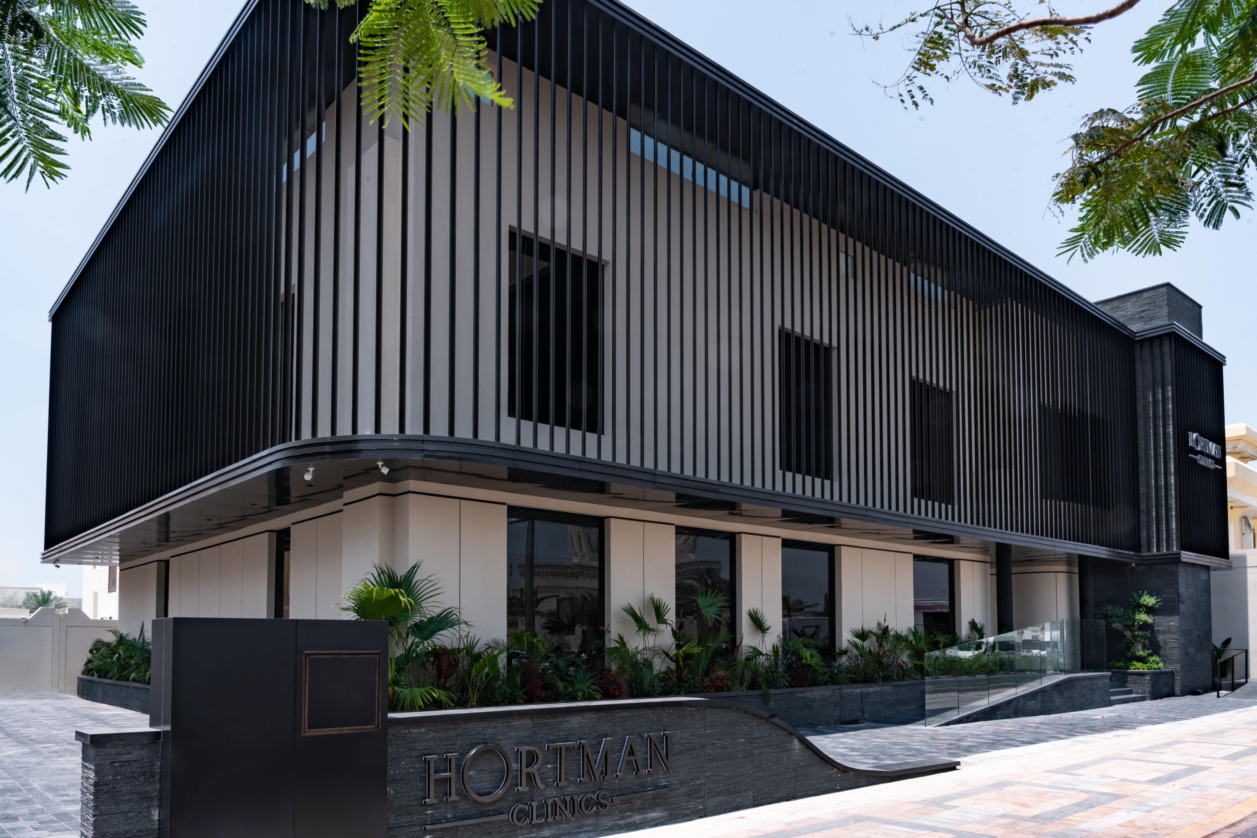 The Hortman Clinics building in Jumeirah 3, black vertical fins over a stone entrance